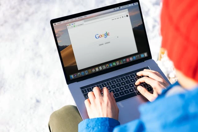 Person using laptop with Google
