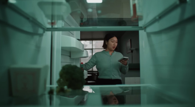 Big sister opening a near-empy fridge. Big sister opening a near-empy fridge.