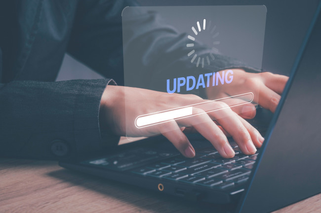 A man installing software updates on a laptop