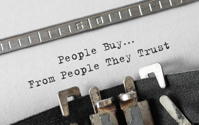 ”People buy from people they trust” written on a paper