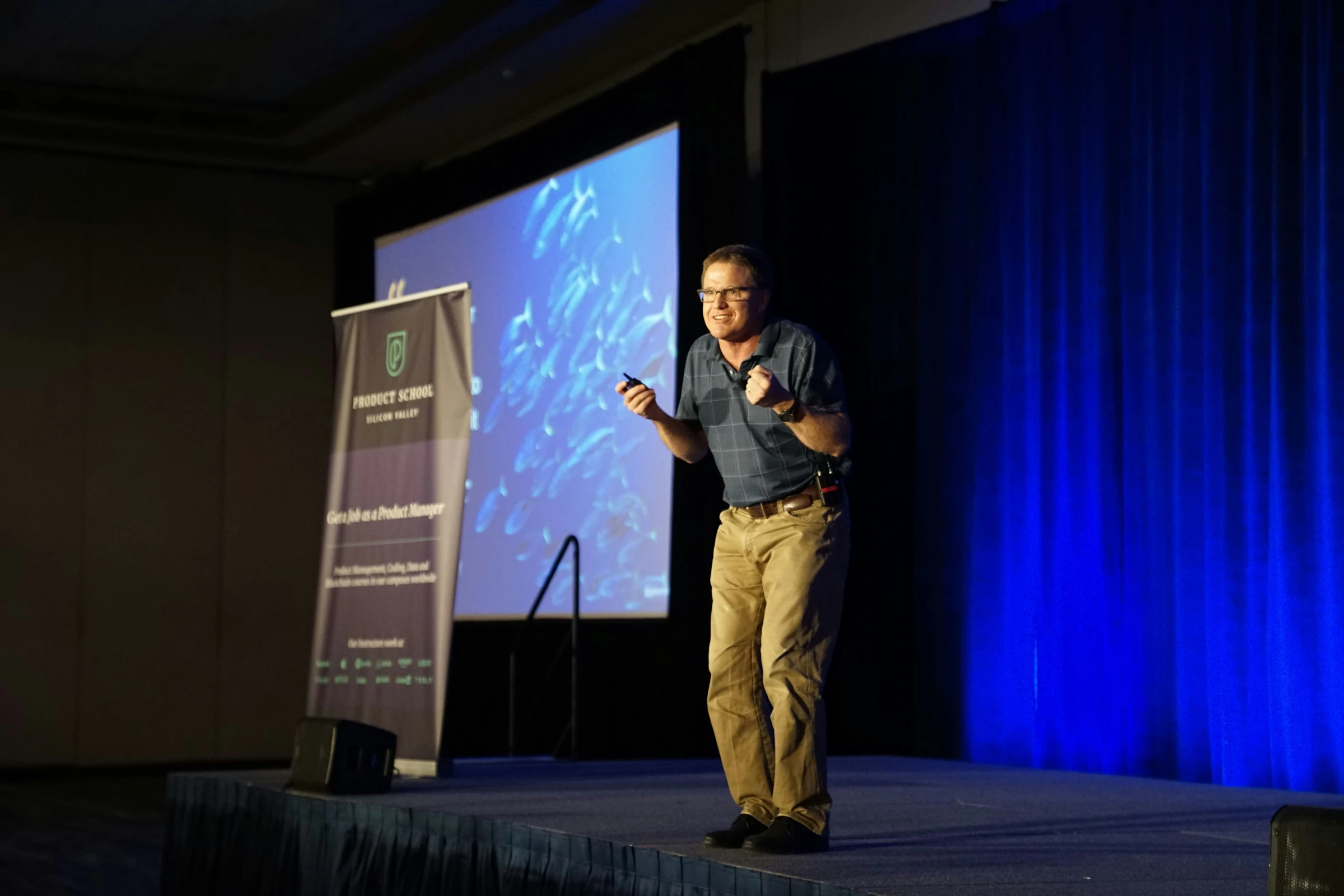 A man coached by a PR agency confidently speaks onstage