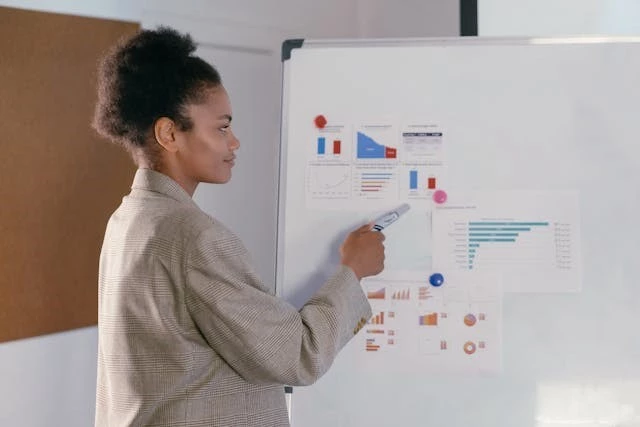 Woman pointing at board