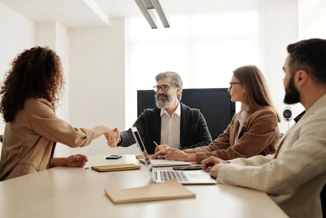 Man in suit shaking hands with woman