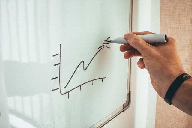 Person drawing on white board