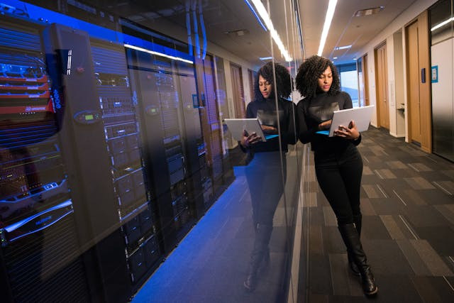 Woman leaning next to servers