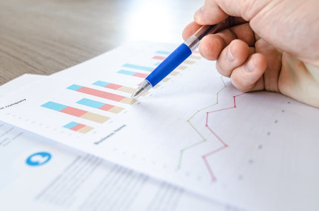 Person pointing at graphs