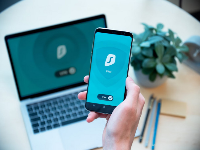Person holding mobile phone with VPN