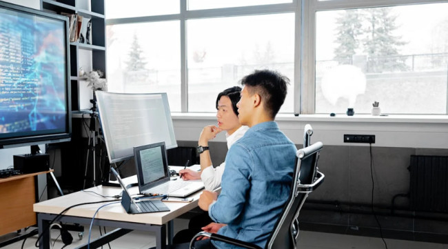 Two men sitting down while having a discussion
