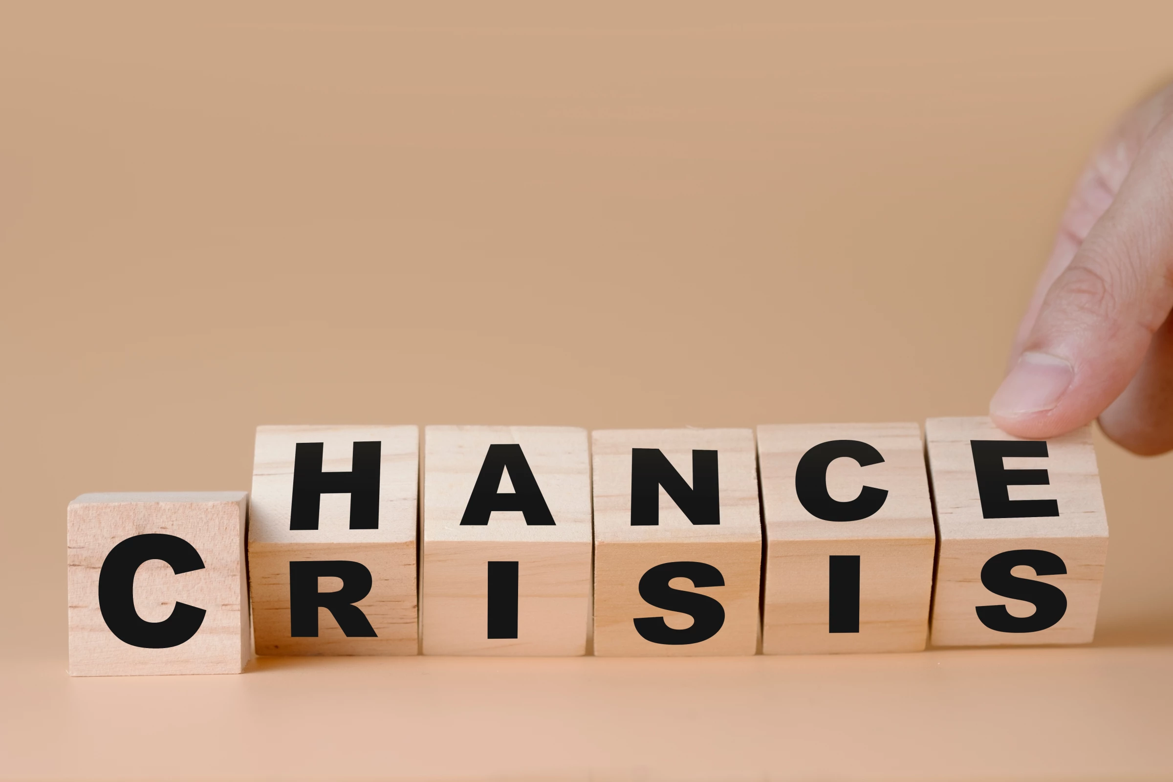 The words ”chance” and ”crisis” written on wooden blocks