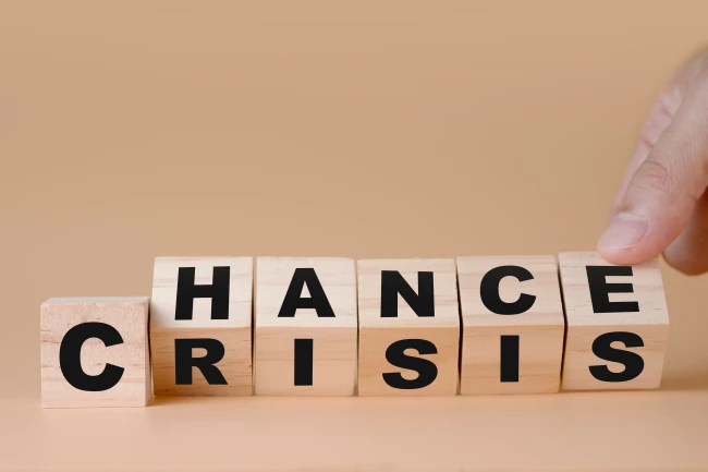The words ”chance” and ”crisis” written on wooden blocks