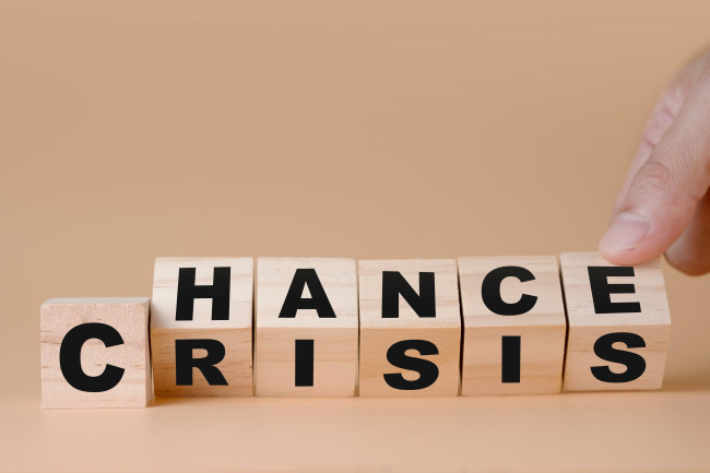 The words ”chance” and ”crisis” written on wooden blocks