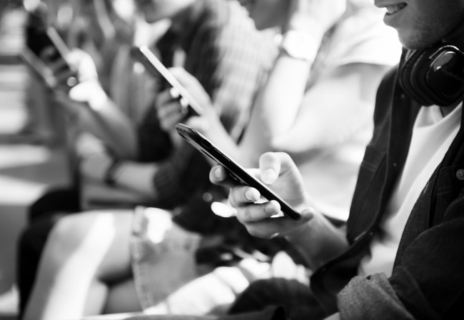 A group of people using smartphones