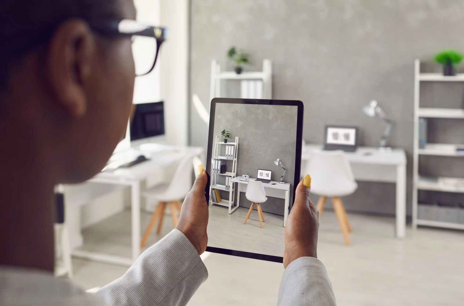 An agent takes a video of the interior of a house. 