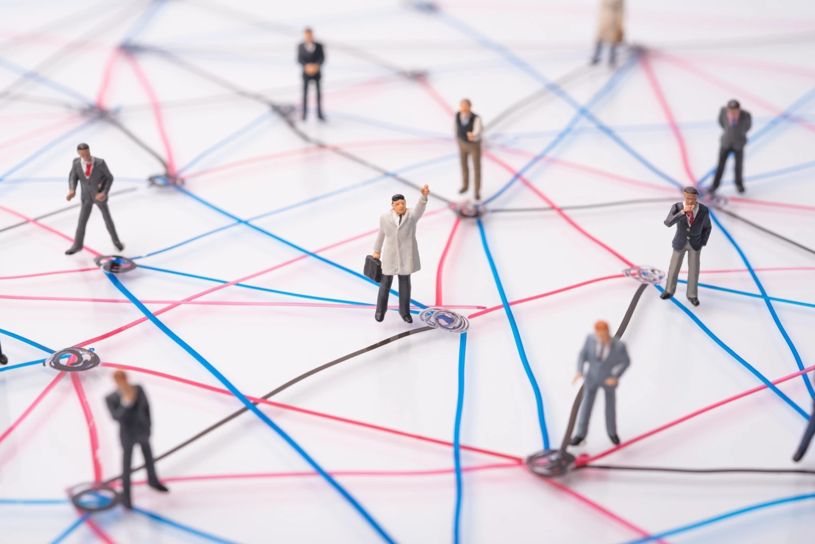 Miniature people connected by red and blue lines