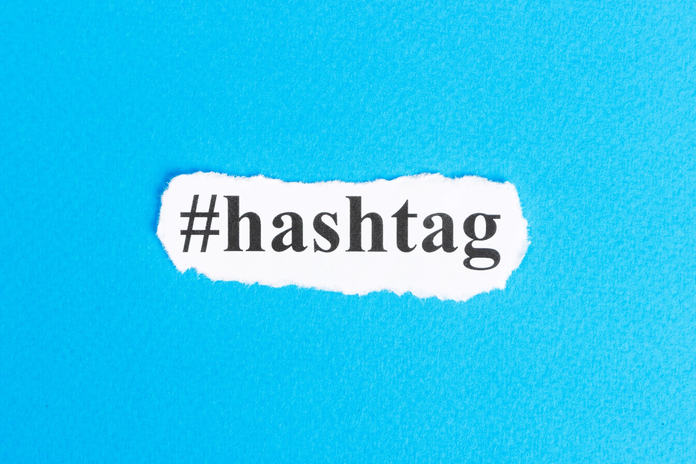 Hashtag text on torn paper