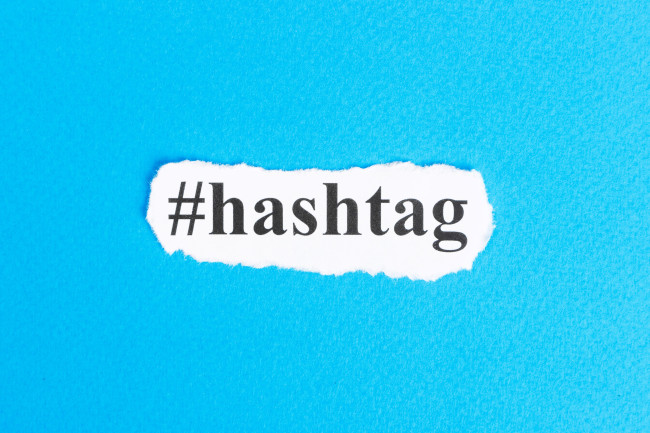 Hashtag text on torn paper