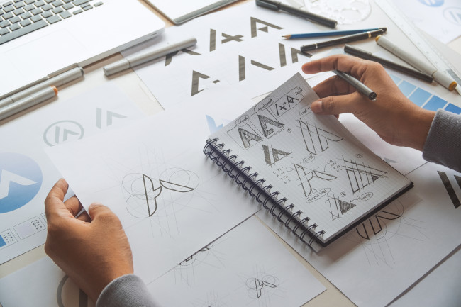 A graphic artist creates different variations of a logo