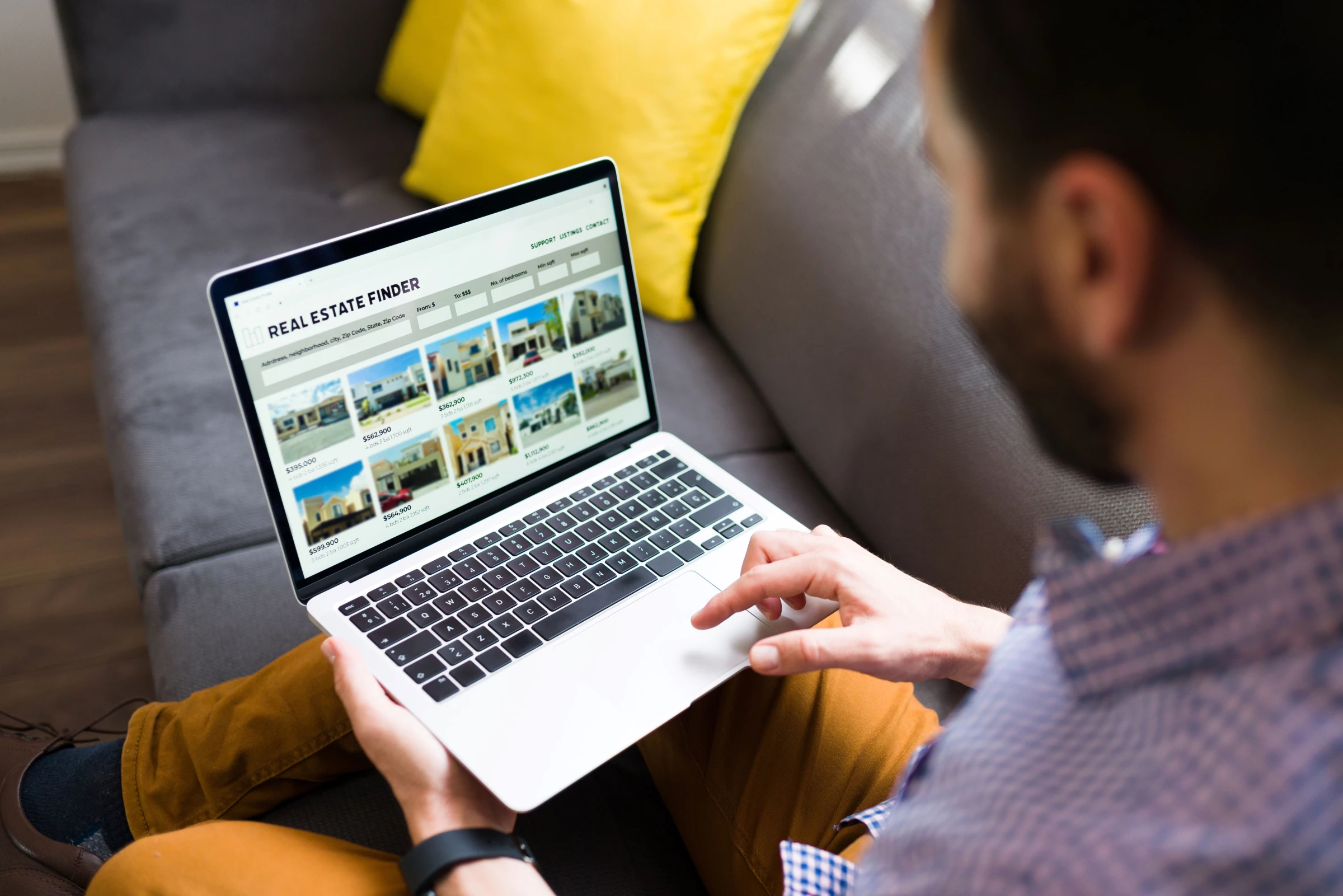 A man checks for properties for sale online