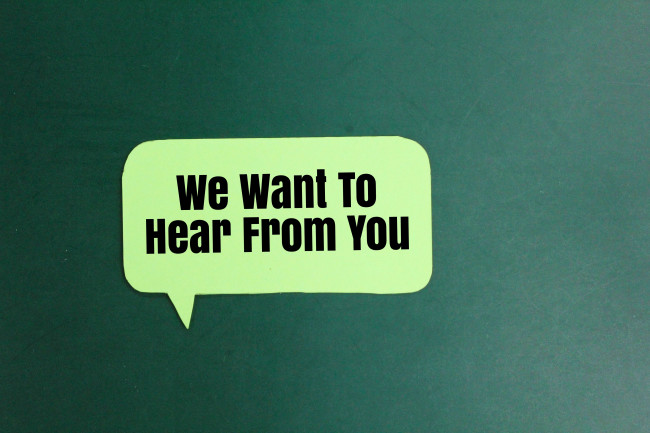 We want to hear from you” written on a conversation bubble