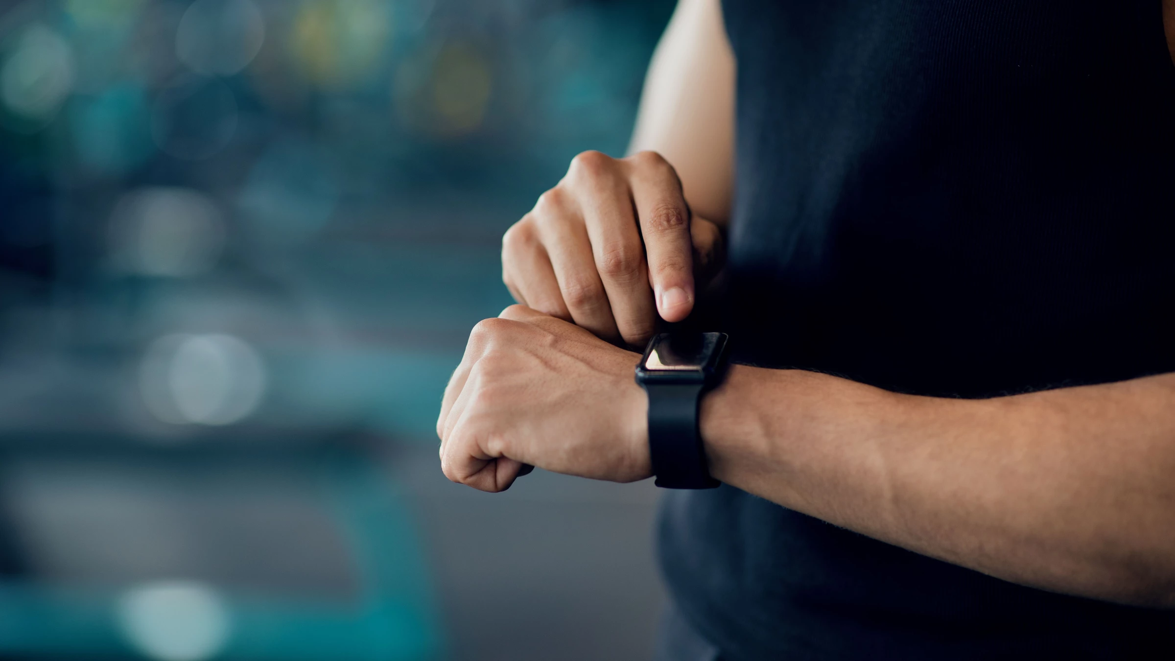 A man points at his smartwatch