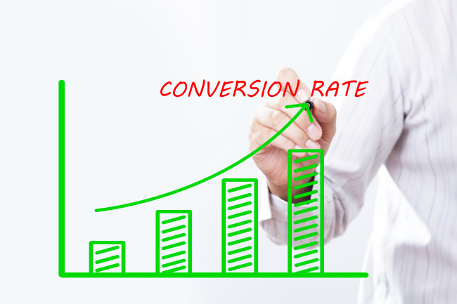 A man draws a graph with an upward arrow signifying an increase in conversion 