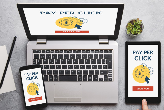 Dollar signs on laptop, tablet, and smartphone 