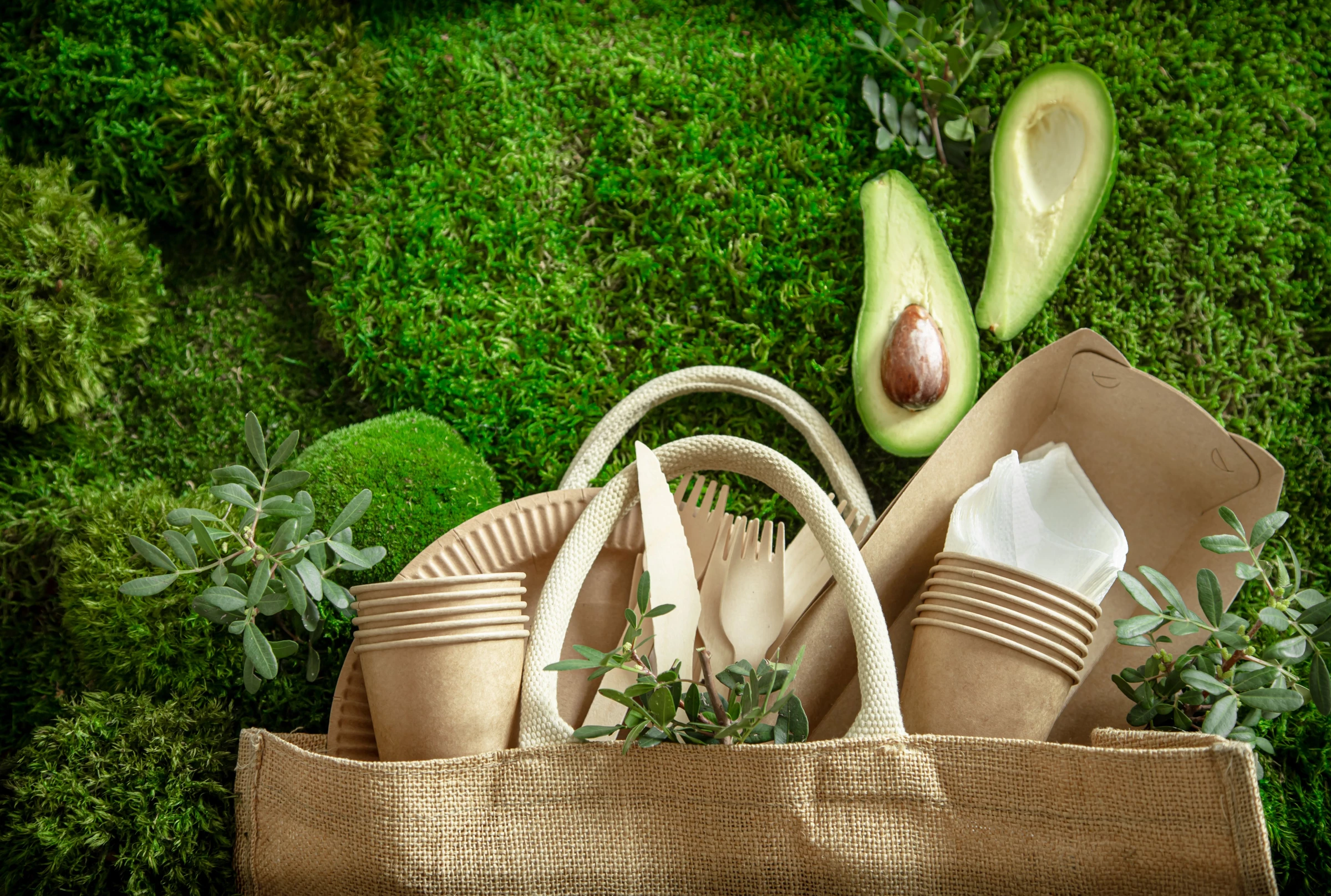 A recyclable bag with paper cups and other sustainable items