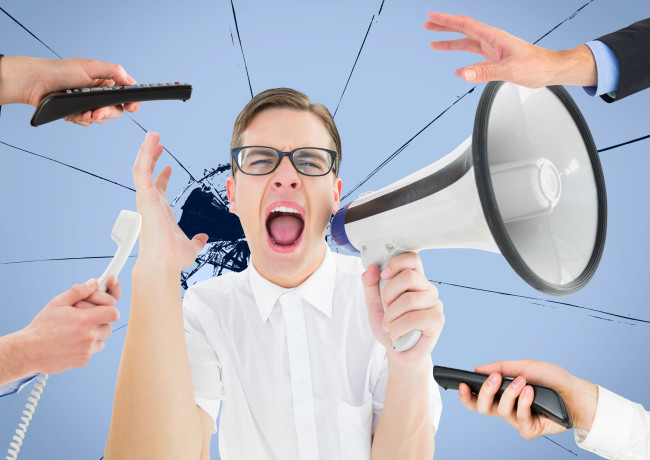 A man holds a megaphone as he is bombarded by calls and comments