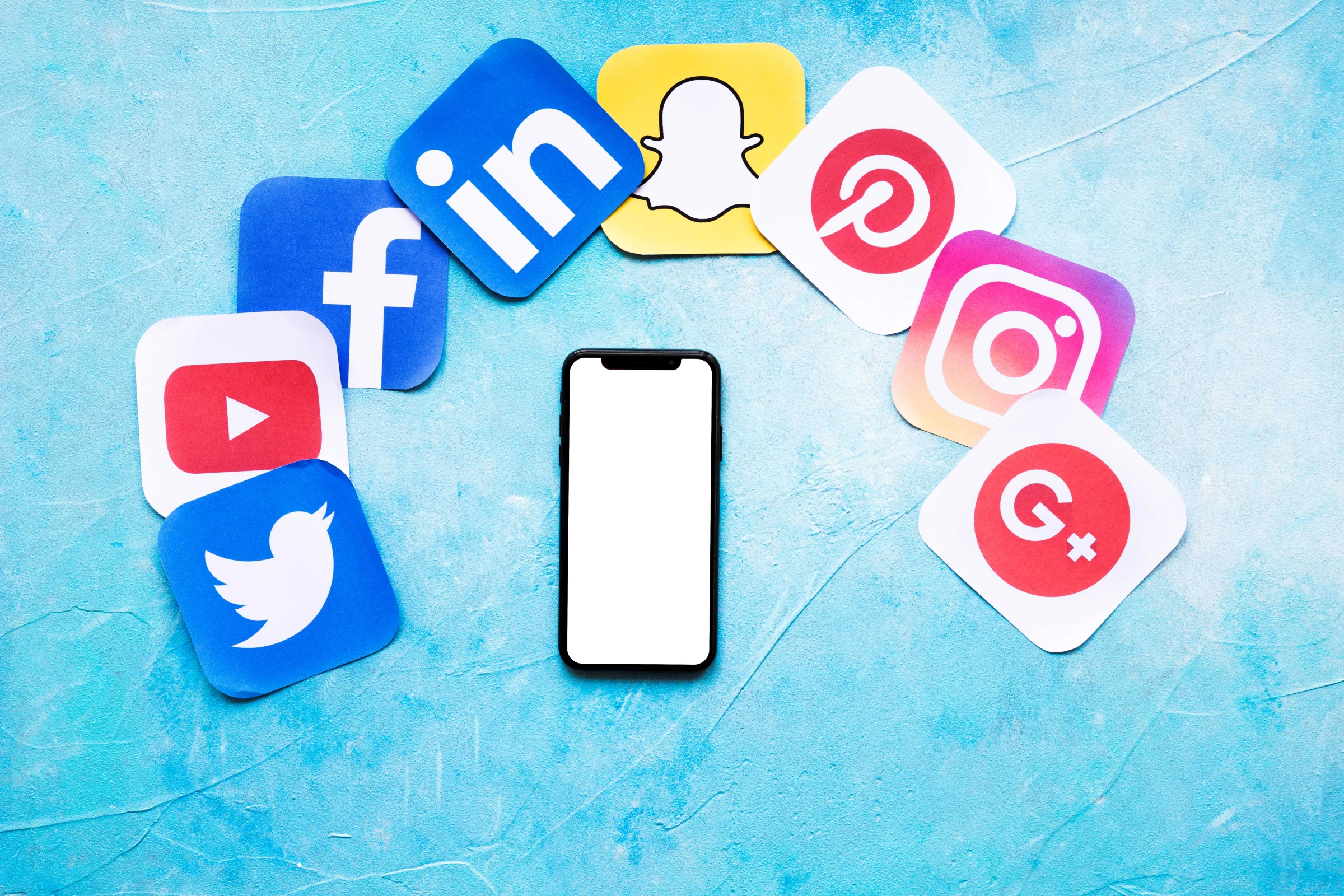 A smartphone with various social networking icons on a blue backdrop