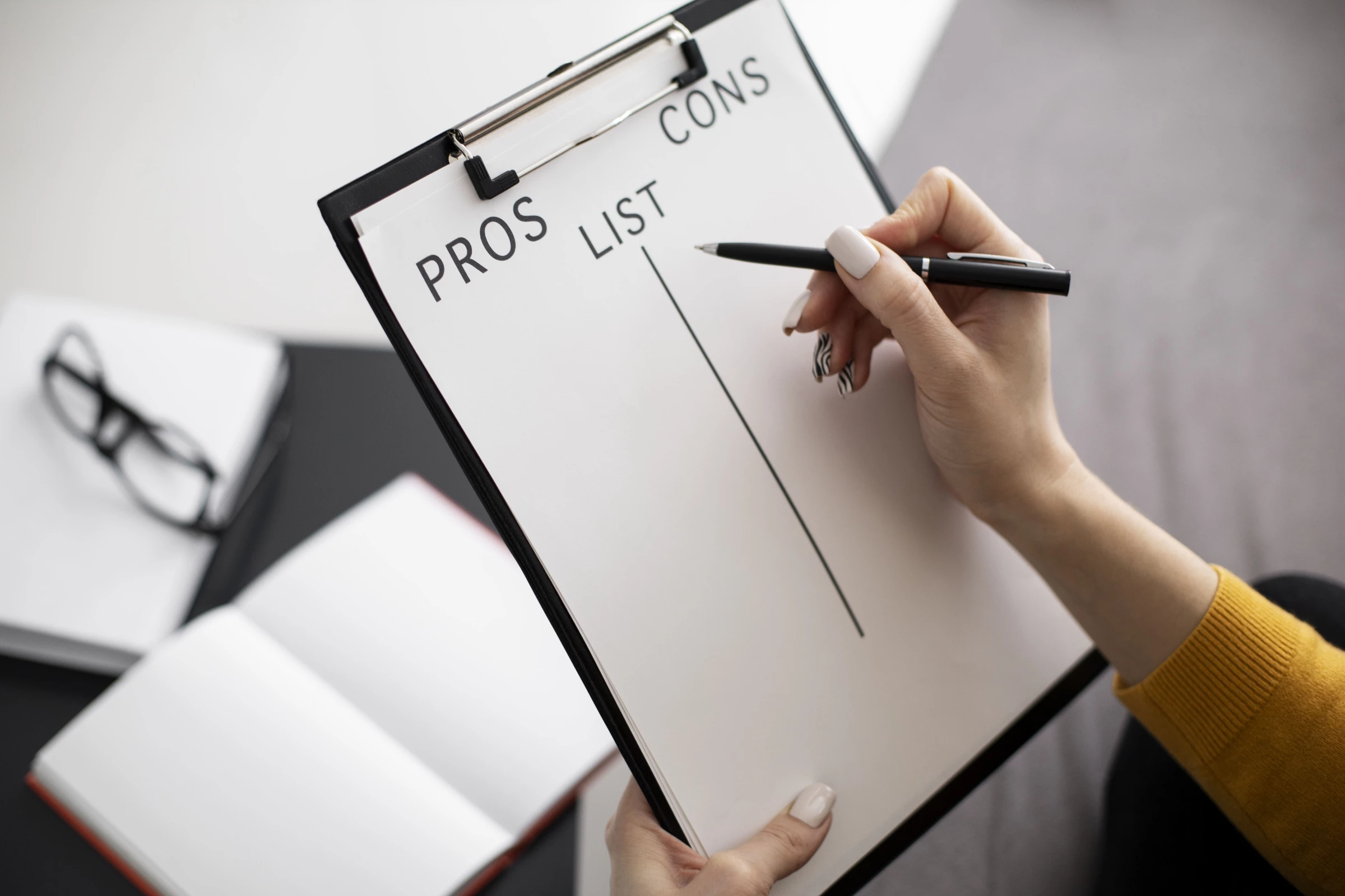 A woman makes a pros and cons list
