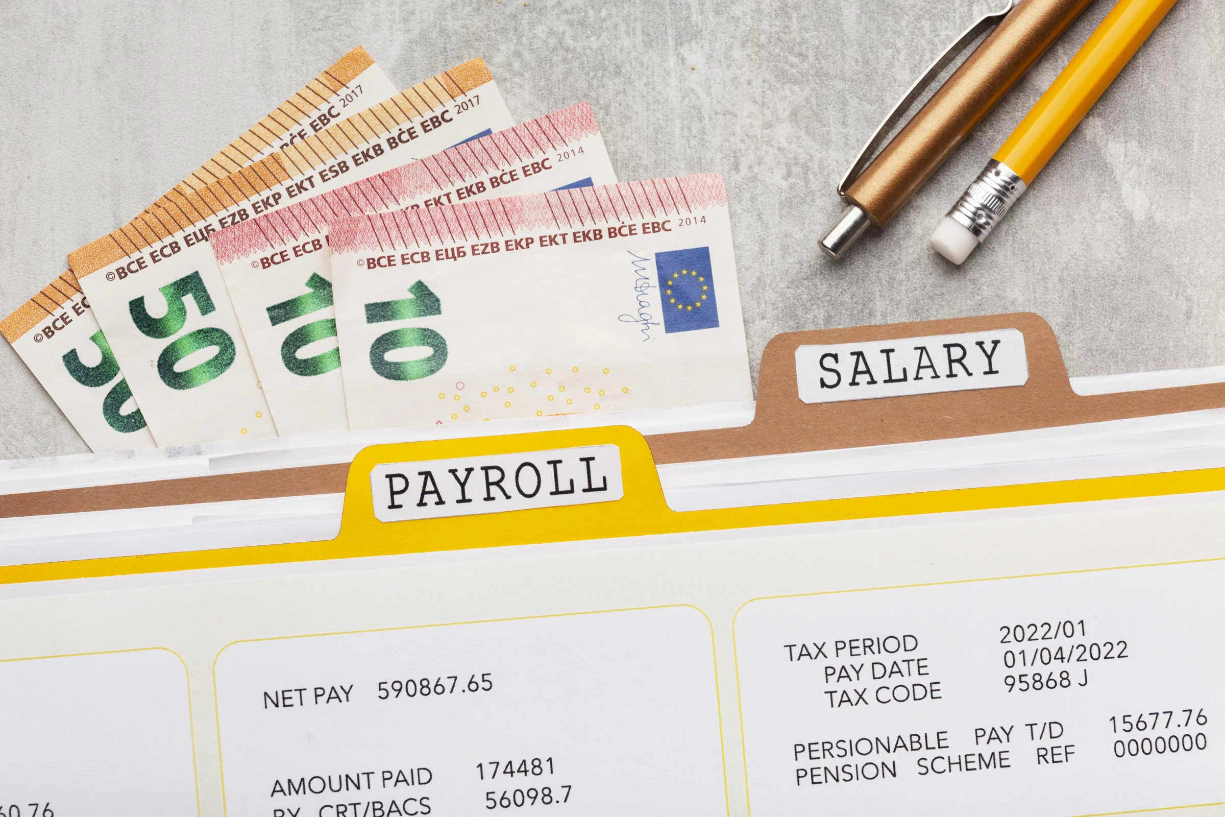 Top view of bank notes and payroll documents