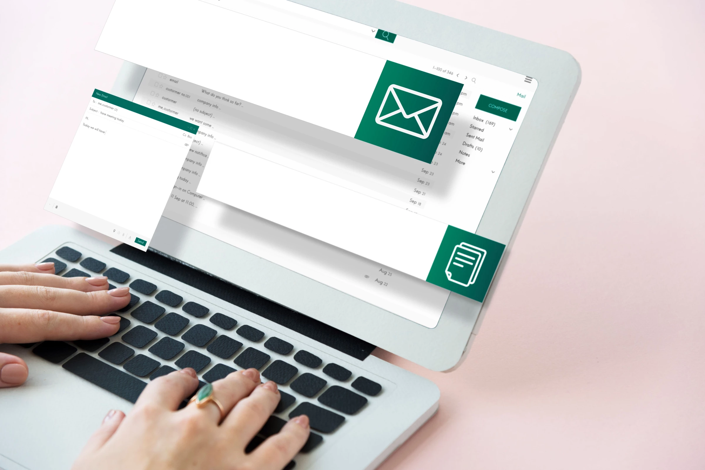 A woman writes an email on a laptop
