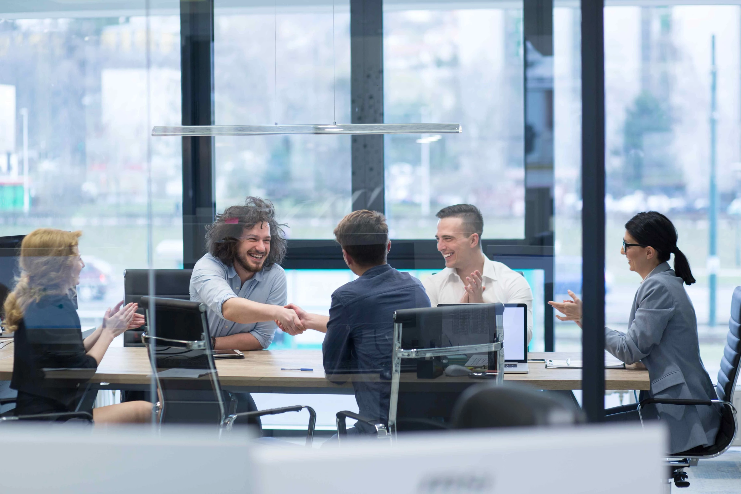 Business professionals shaking hands in a meeting