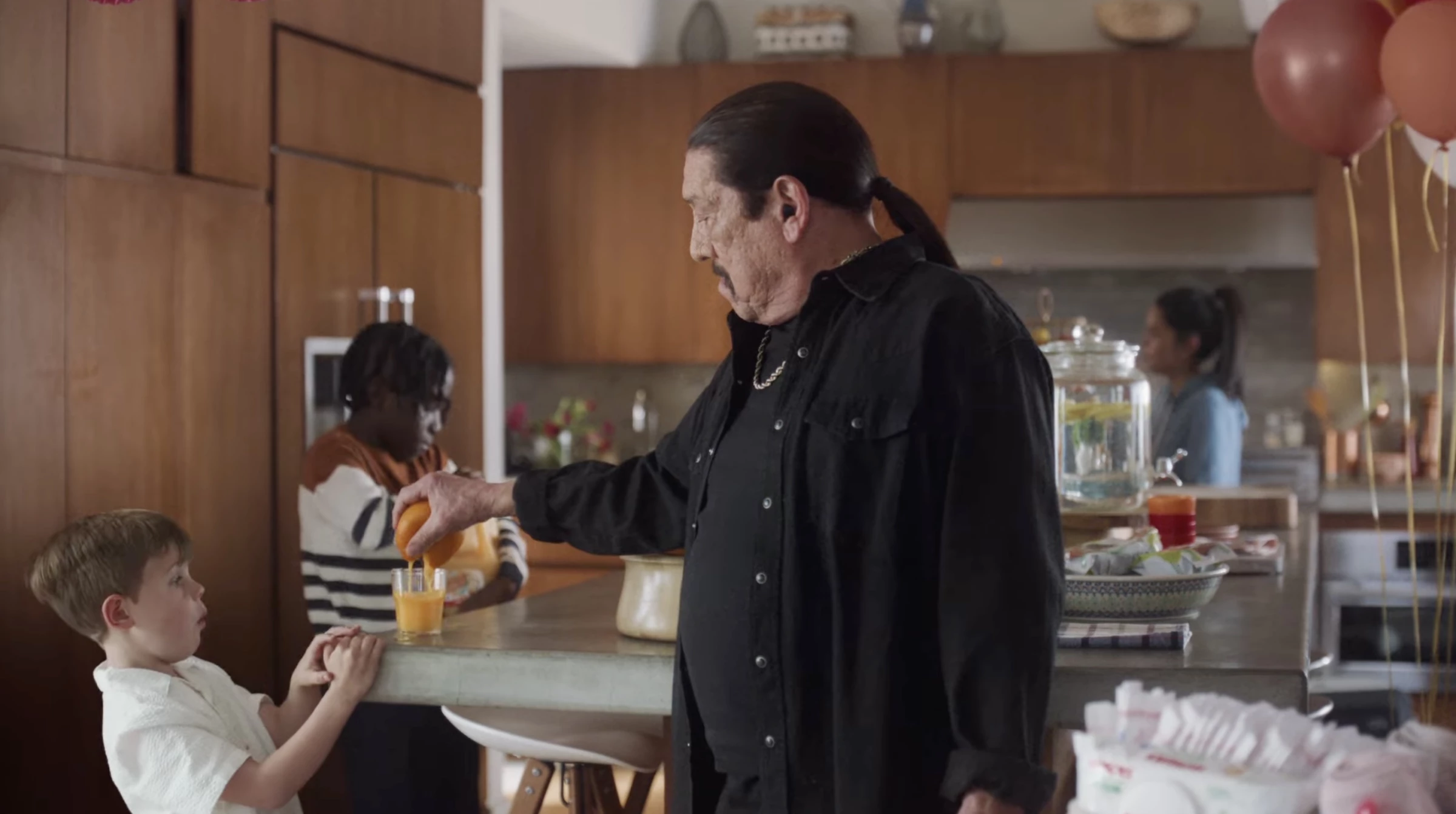Trejo squeezes an orange with his bare hands after seeing a kid having a hard time opening a jar of OJ.