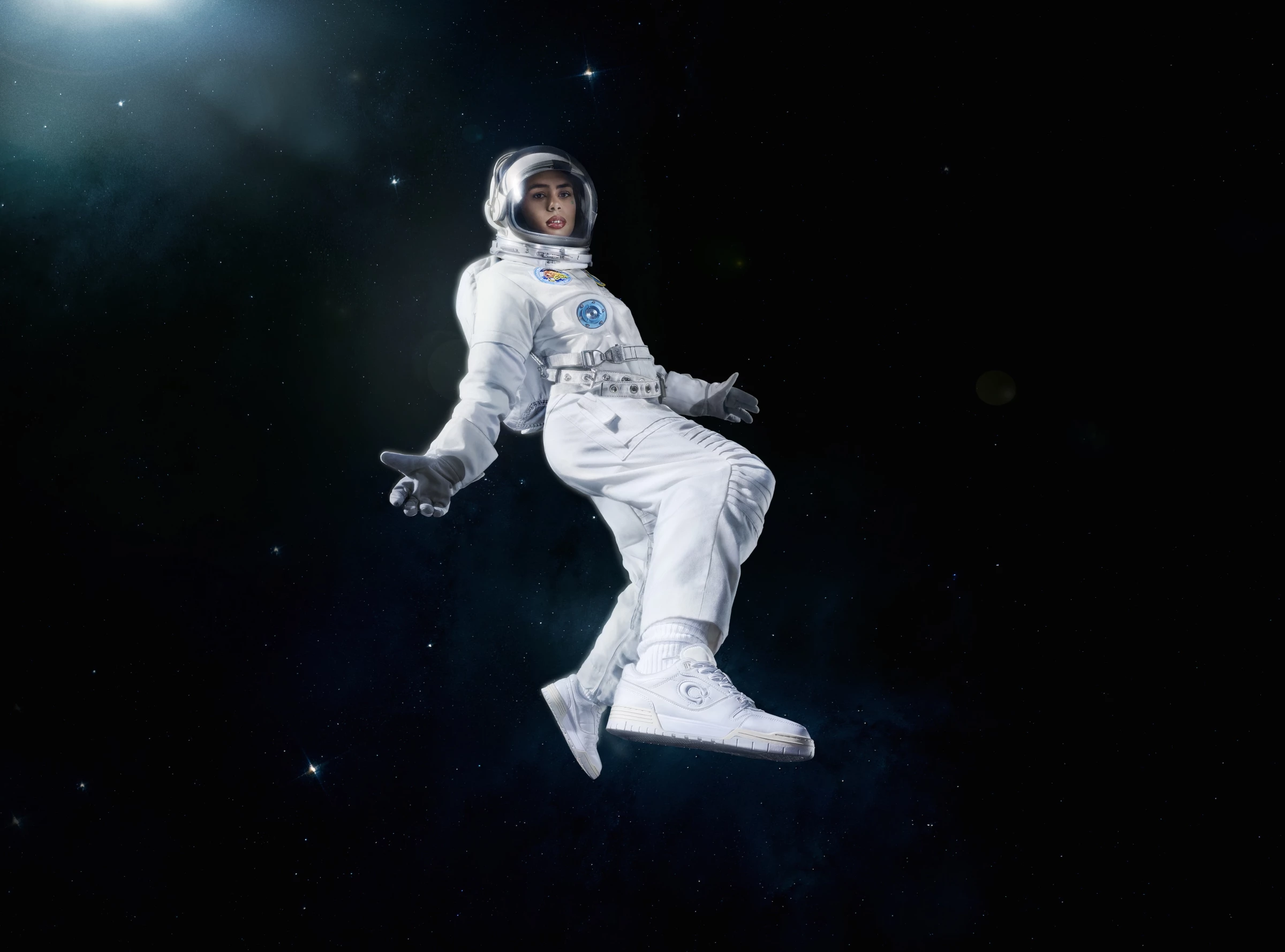 Giovanna Ramos models the Coach sneakers as an astronaut