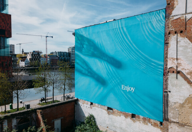 Coca-Cola bottles casting a shadow on a pool | Source: Coca-Cola Coca-Cola bottles casting a shadow on a pool | Source: Coca-Cola