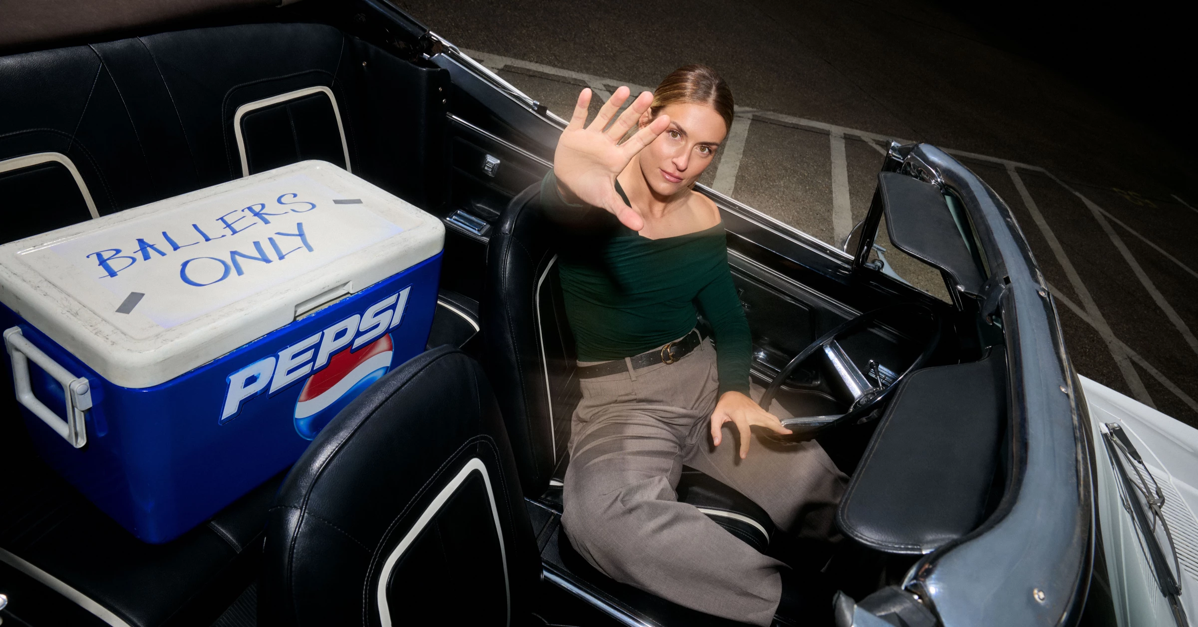 Alexia Putellas poses in a convertible with a Pepsi cooler.