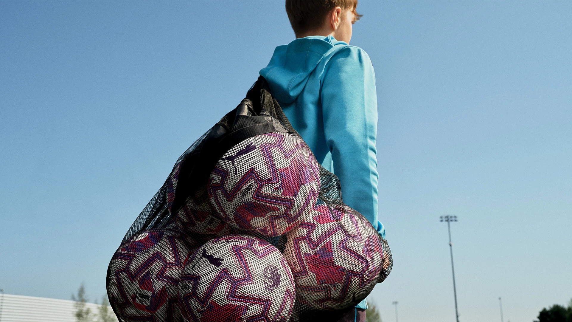 The PUMA match balls carried by a young football player