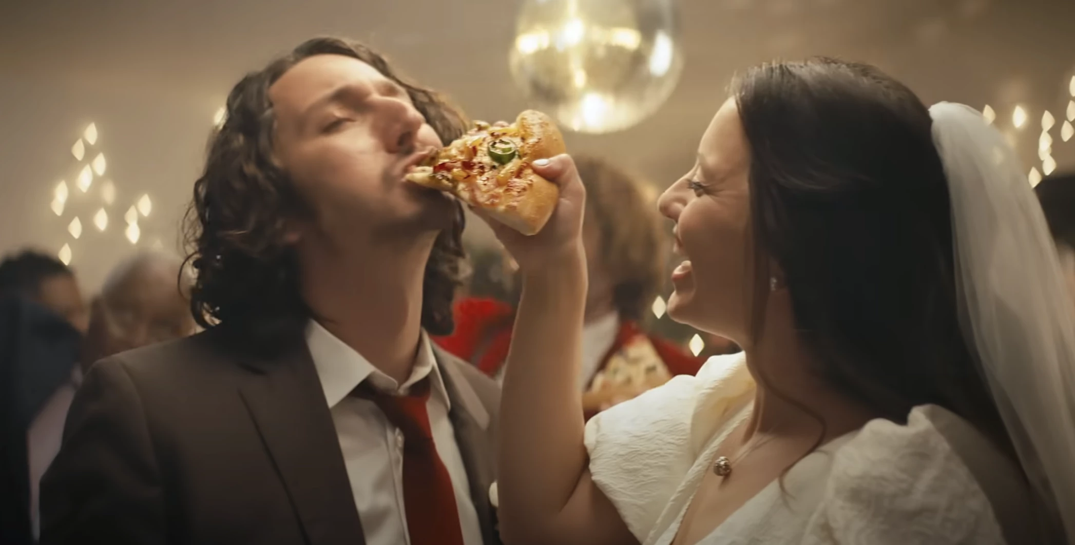 A bride and her groom enjoy Pizza Hut's newest Spicy Hawaiian | Source: Pizza Hut