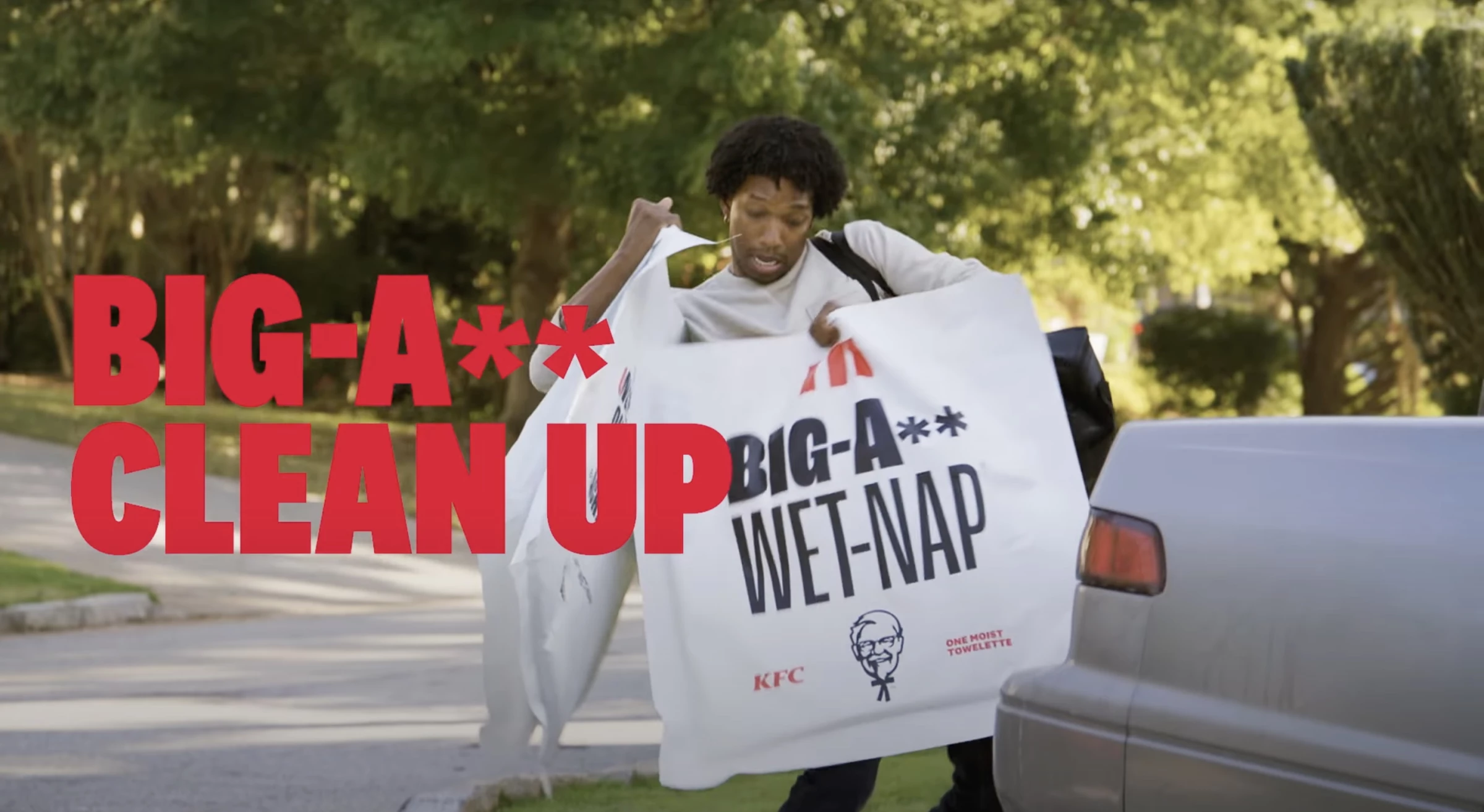 A man taking out KFC's Big-A** Wet Nap from his trunk