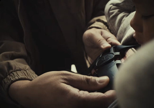 A father buckles his son up to the Superhero Belt | Source: Toyota